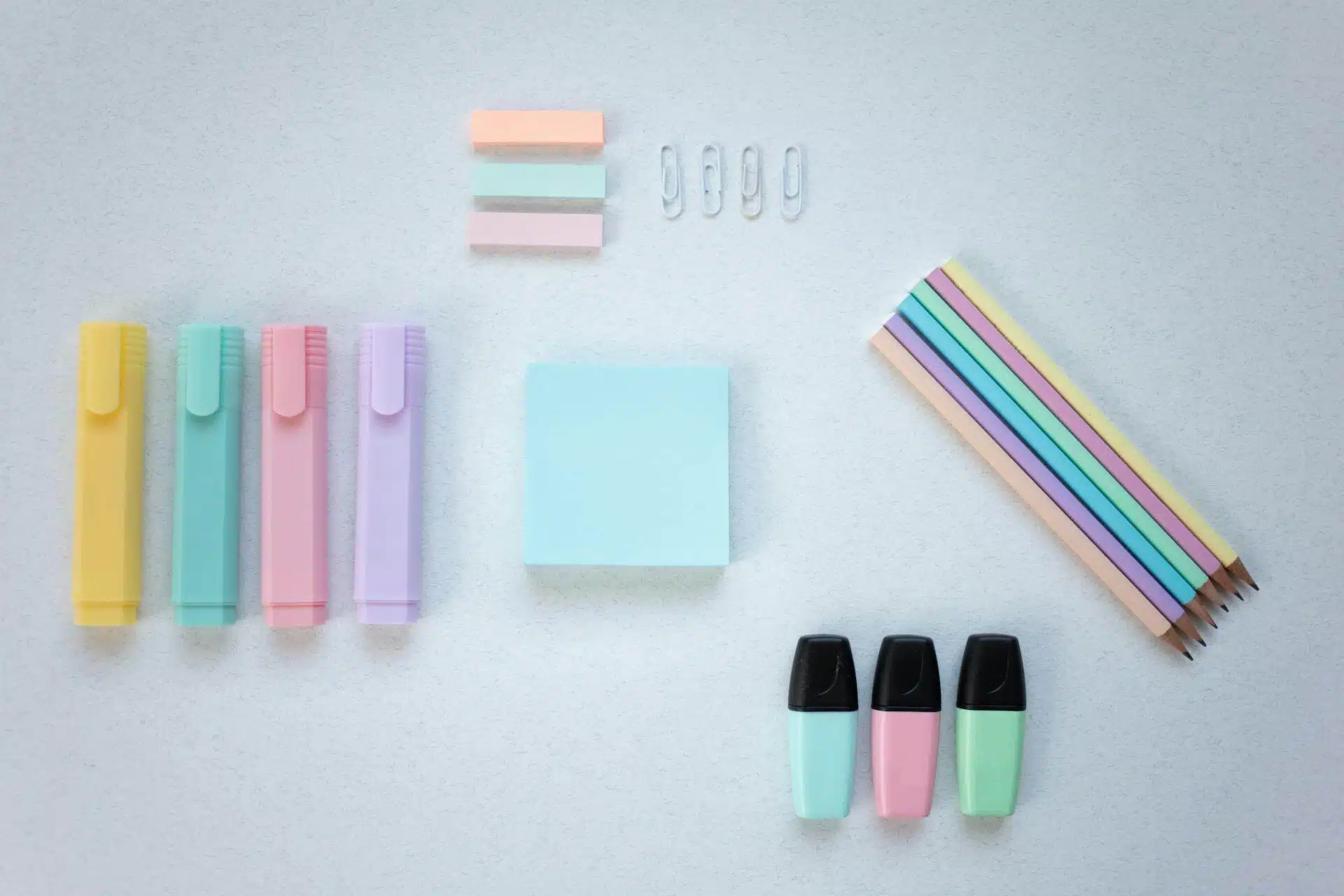 A Variety of Office Supplies Neatly Arranged on a Light Grey Surface